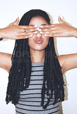 Buy stock photo Studio shot of an attractive young woman covering her eyes