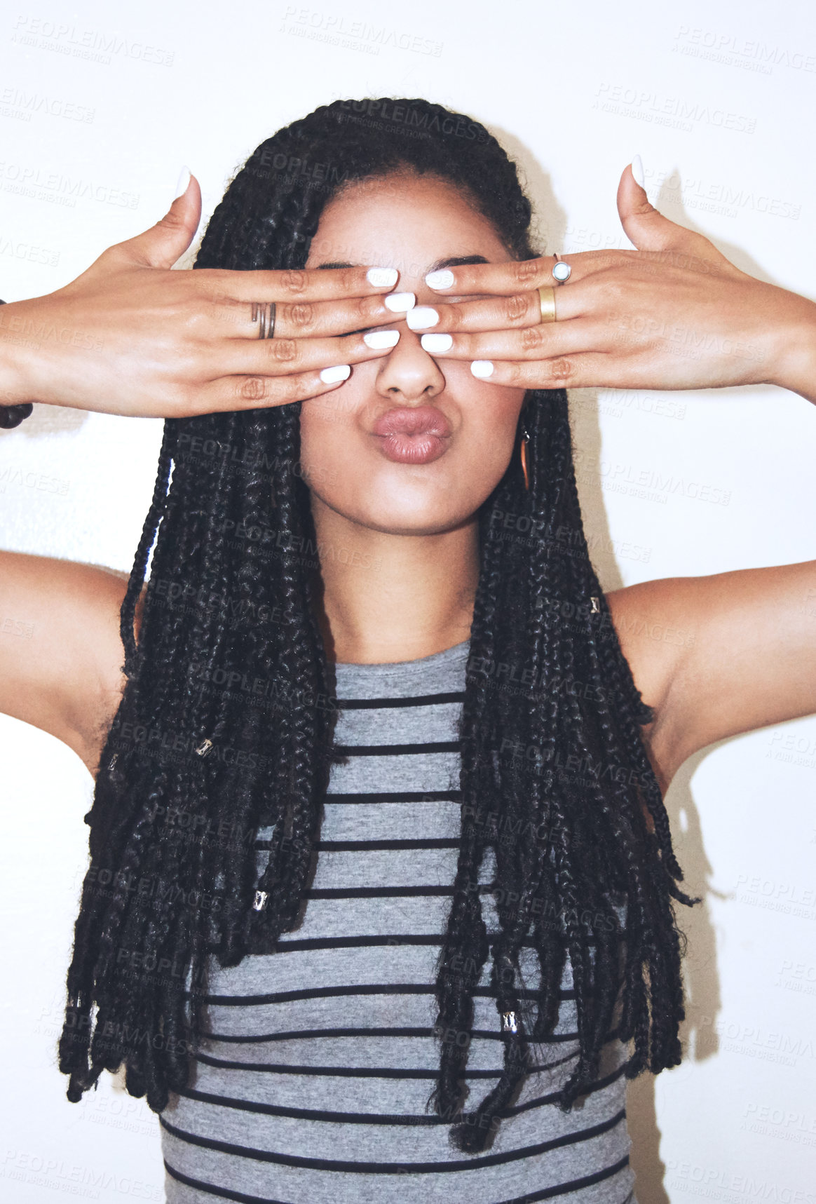 Buy stock photo Studio shot of an attractive young woman covering her eyes