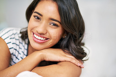 Buy stock photo Cropped portrait of a young woman relaxing at home on the weekend