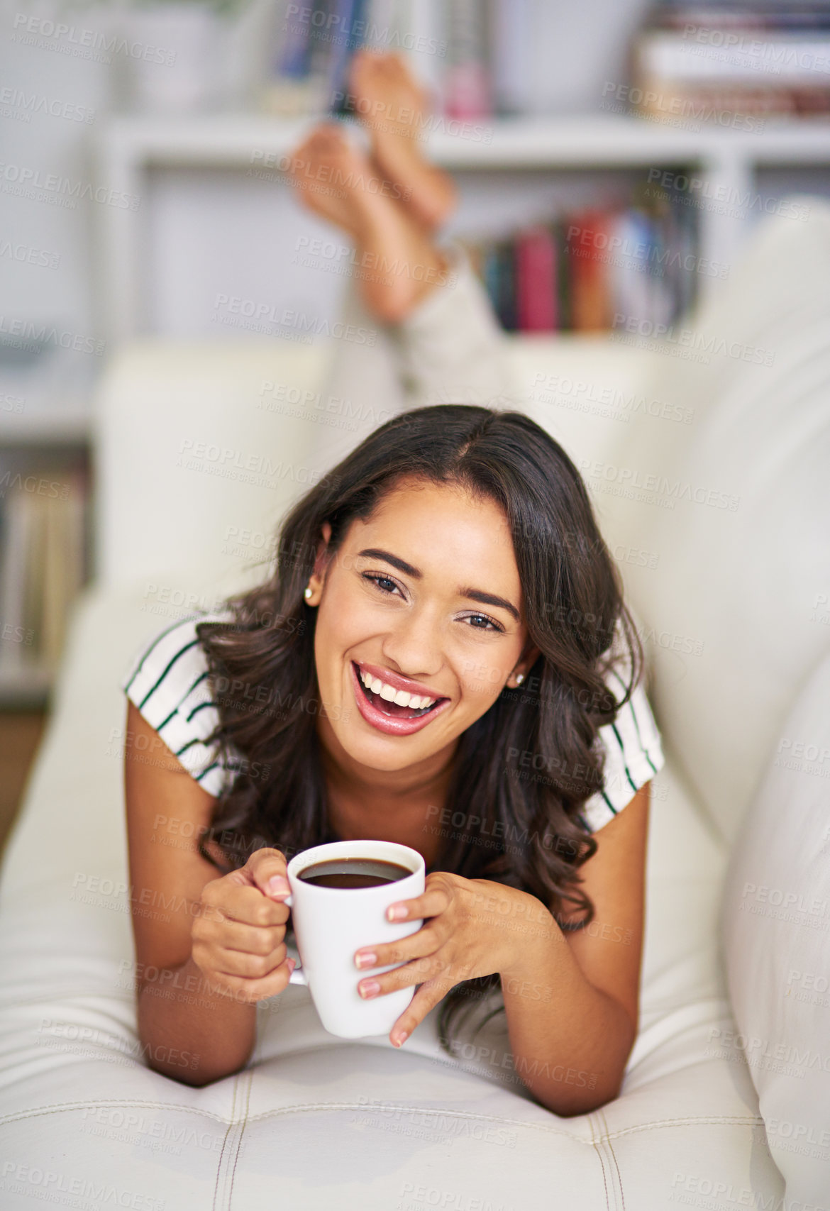 Buy stock photo Full length portrait of a young woman drinking coffee while relaxing on her sofa at home