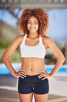 Buy stock photo Shot of a sporty young woman posing with her hands on her hips