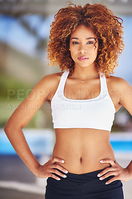 Buy stock photo Shot of a sporty young woman posing with her hands on her hips