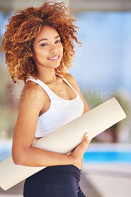 Buy stock photo Cropped shot of a sporty young woman holding her yoga mat