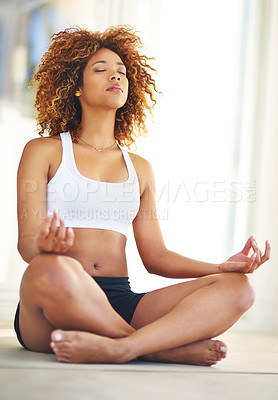 Buy stock photo Shot of a young woman practising her yoga routine