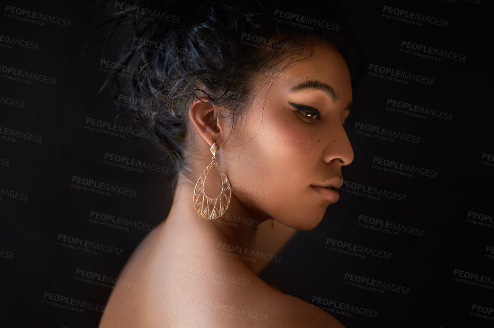 Buy stock photo Cropped shot of a beautiful young woman against a dark background