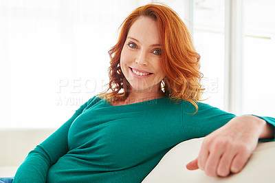 Buy stock photo Cropped portrait of a mature woman relaxing on the sofa at home