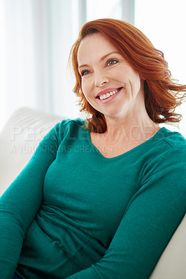 Buy stock photo Cropped shot of a mature woman relaxing on the sofa at home