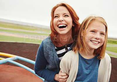Buy stock photo Shot of a mature woman and her young daughter at the park