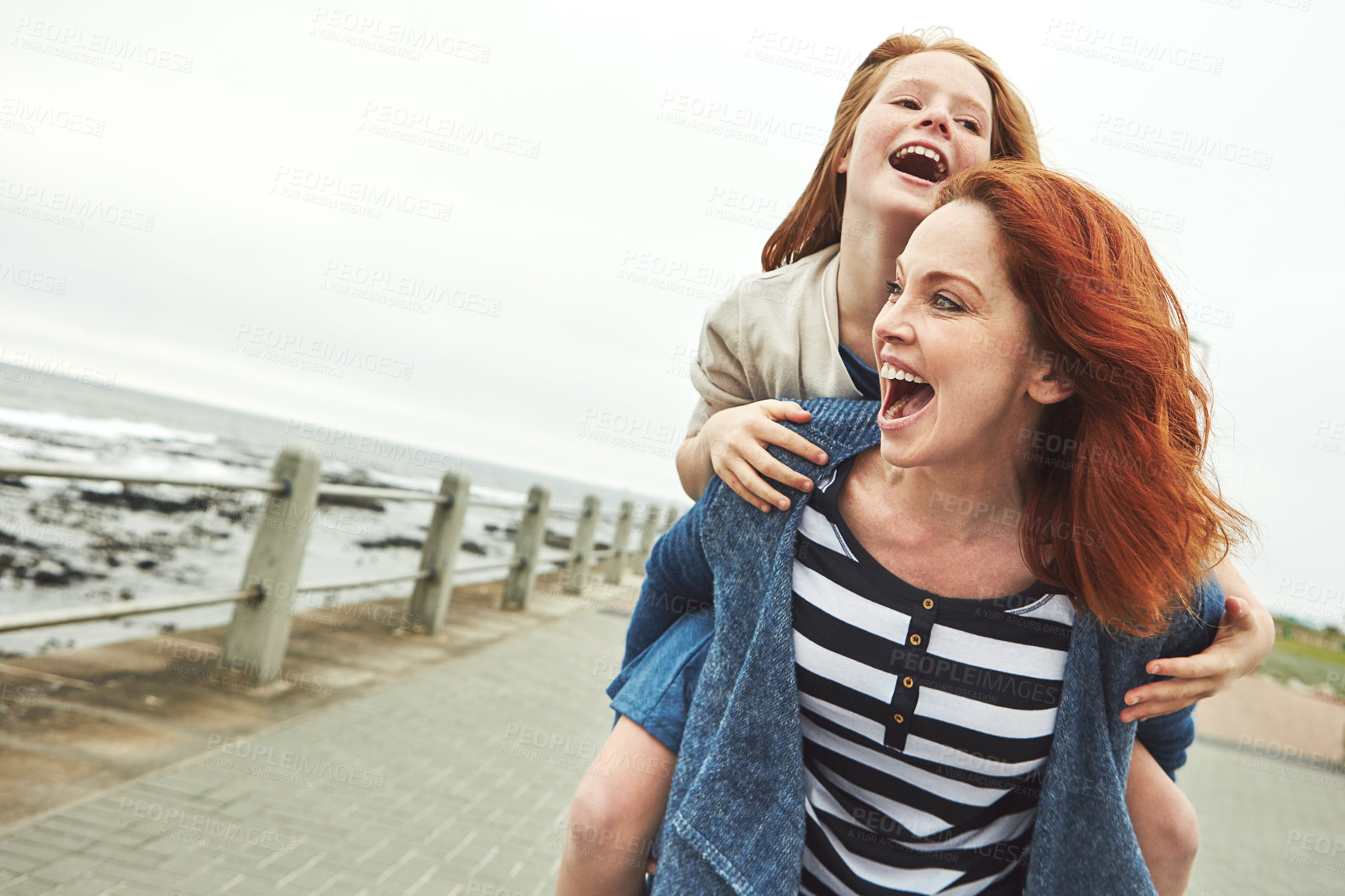 Buy stock photo Shot of a mother giving her daughter a piggyback ride