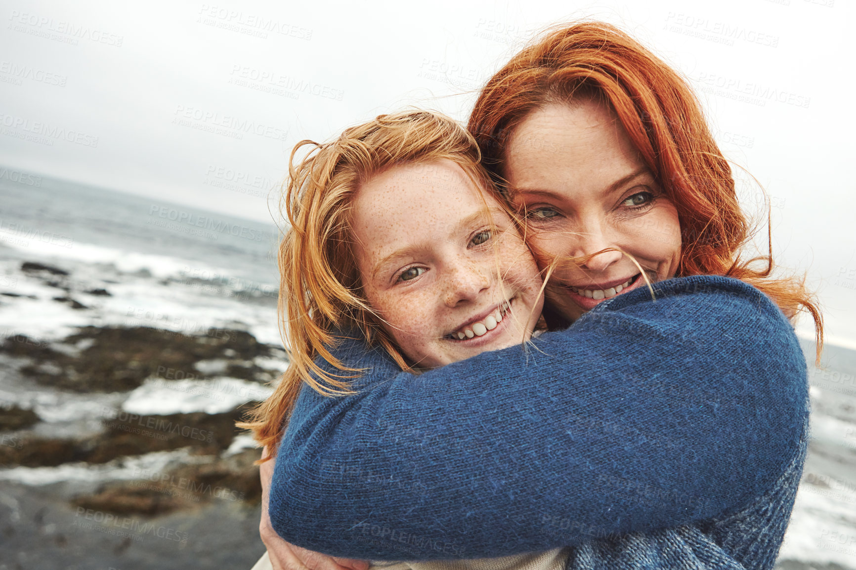 Buy stock photo Shot of a mature woman and her young daughter at the waterfront