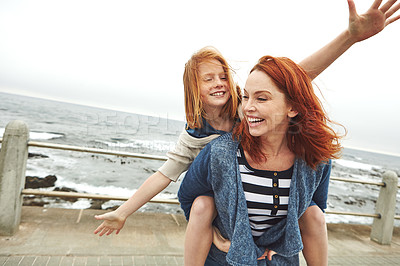 Buy stock photo Shot of a mother giving her daughter a piggyback ride