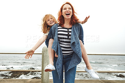 Buy stock photo Shot of a mother giving her daughter a piggyback ride