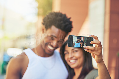 Buy stock photo Shot of a young couple taking a selfie together
