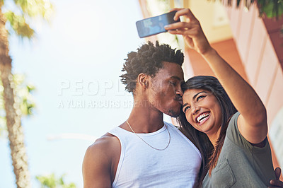 Buy stock photo Selfie, kiss and interracial couple with phone in the city, date and happiness with memory together. 5g technology, love and black man and woman with affection for a mobile photo with a smile