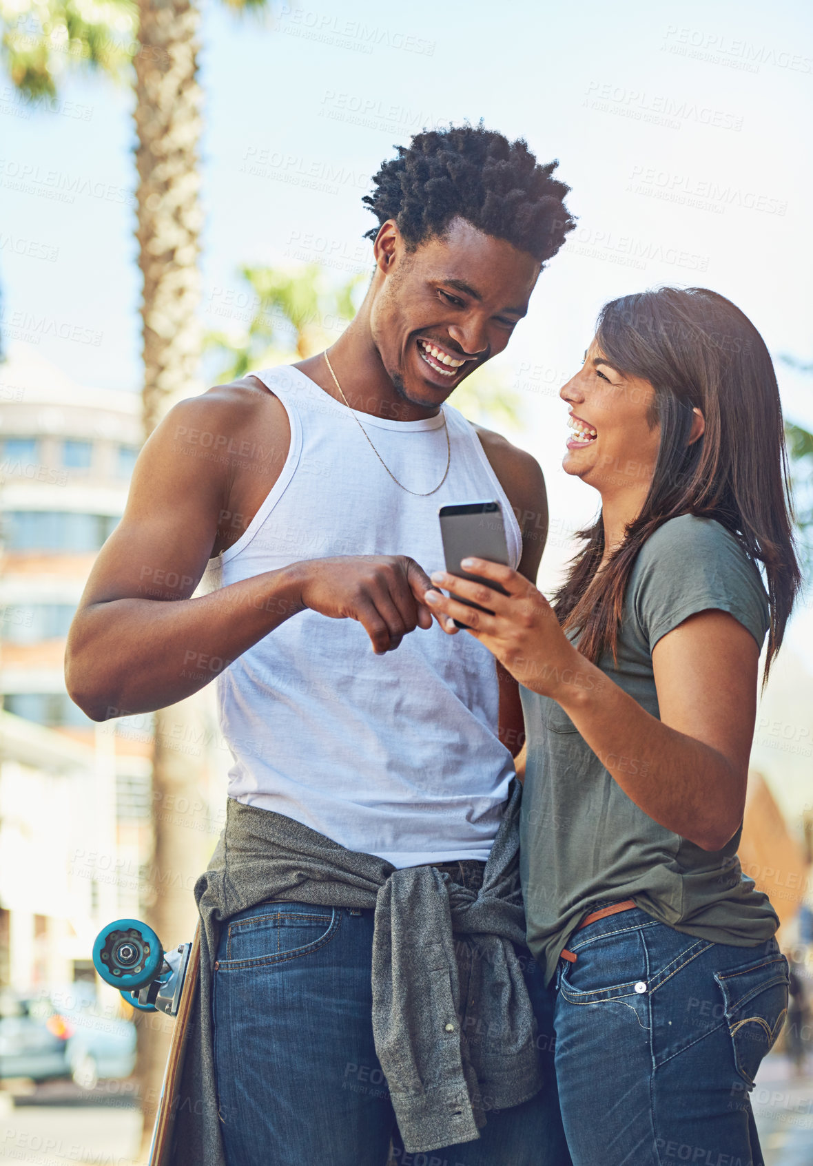Buy stock photo Happy, smile and couple on a phone in city watching a comic, comedy or funny video on social media. Happiness, love and interracial man and woman scrolling online on the internet in urban town road.