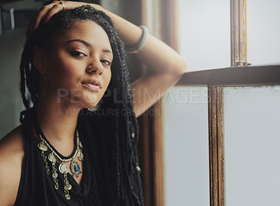 Buy stock photo Cropped shot of an attractive young woman standing by the window
