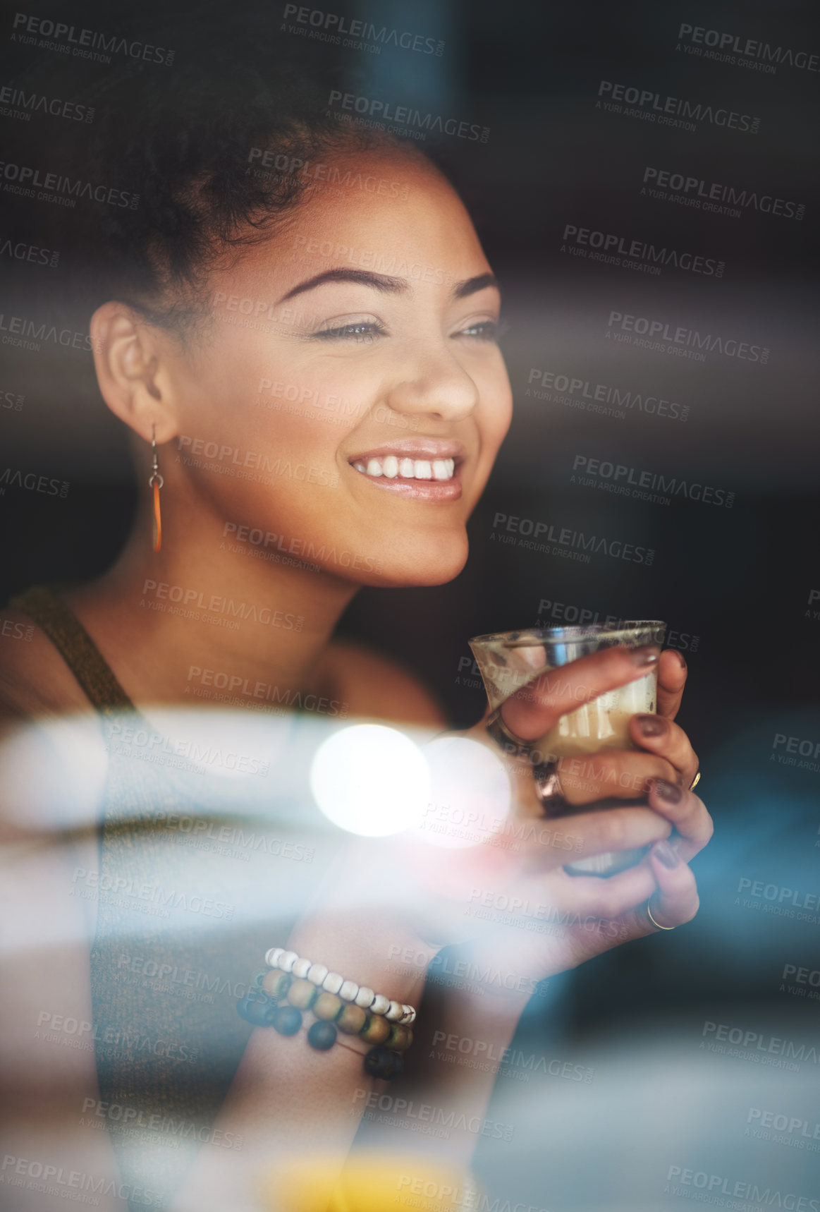Buy stock photo Cropped shot of an attractive young woman sitting in a coffee shop