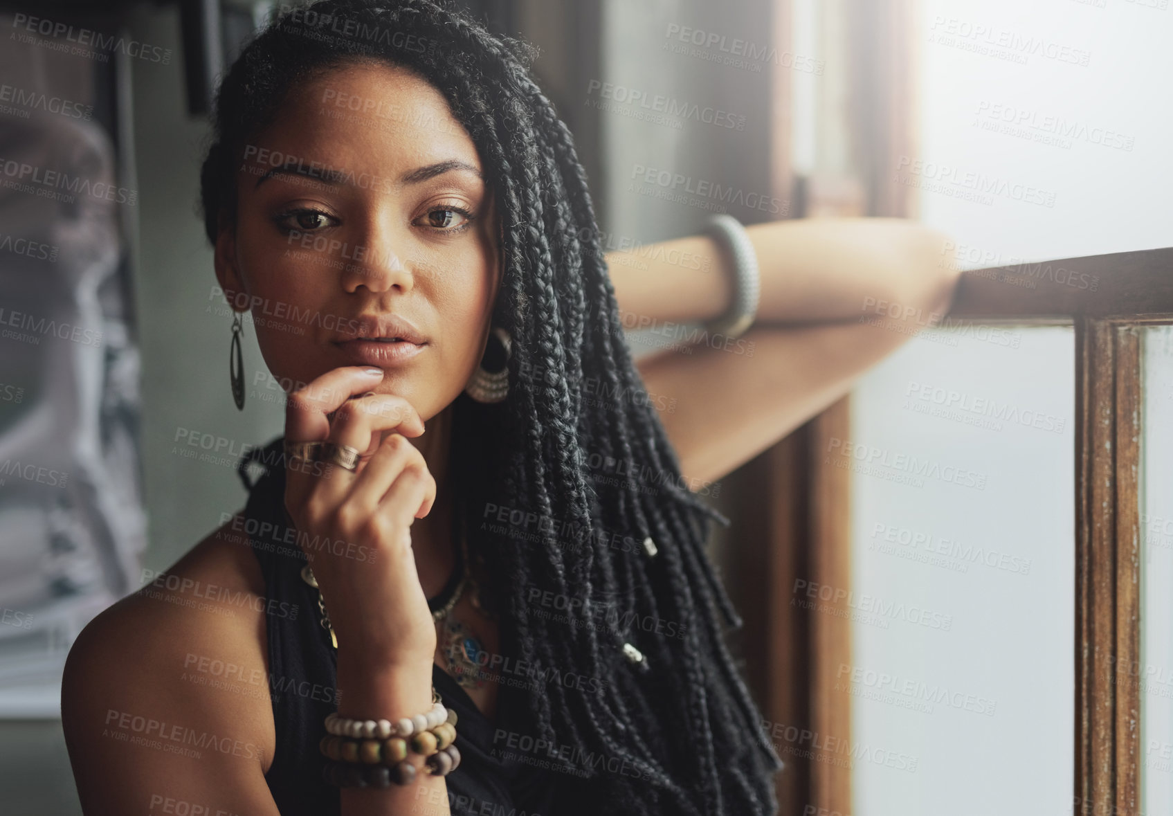 Buy stock photo Cropped shot of an attractive young woman standing by the window