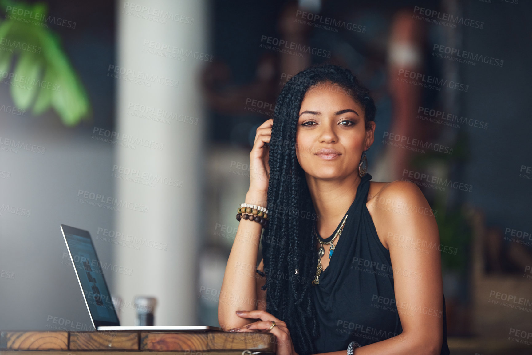 Buy stock photo Cropped portrait of an attractive young woman using her laptop in a coffee shop