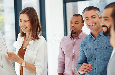 Buy stock photo Cropped shot of four businesspeople working at a whiteboard