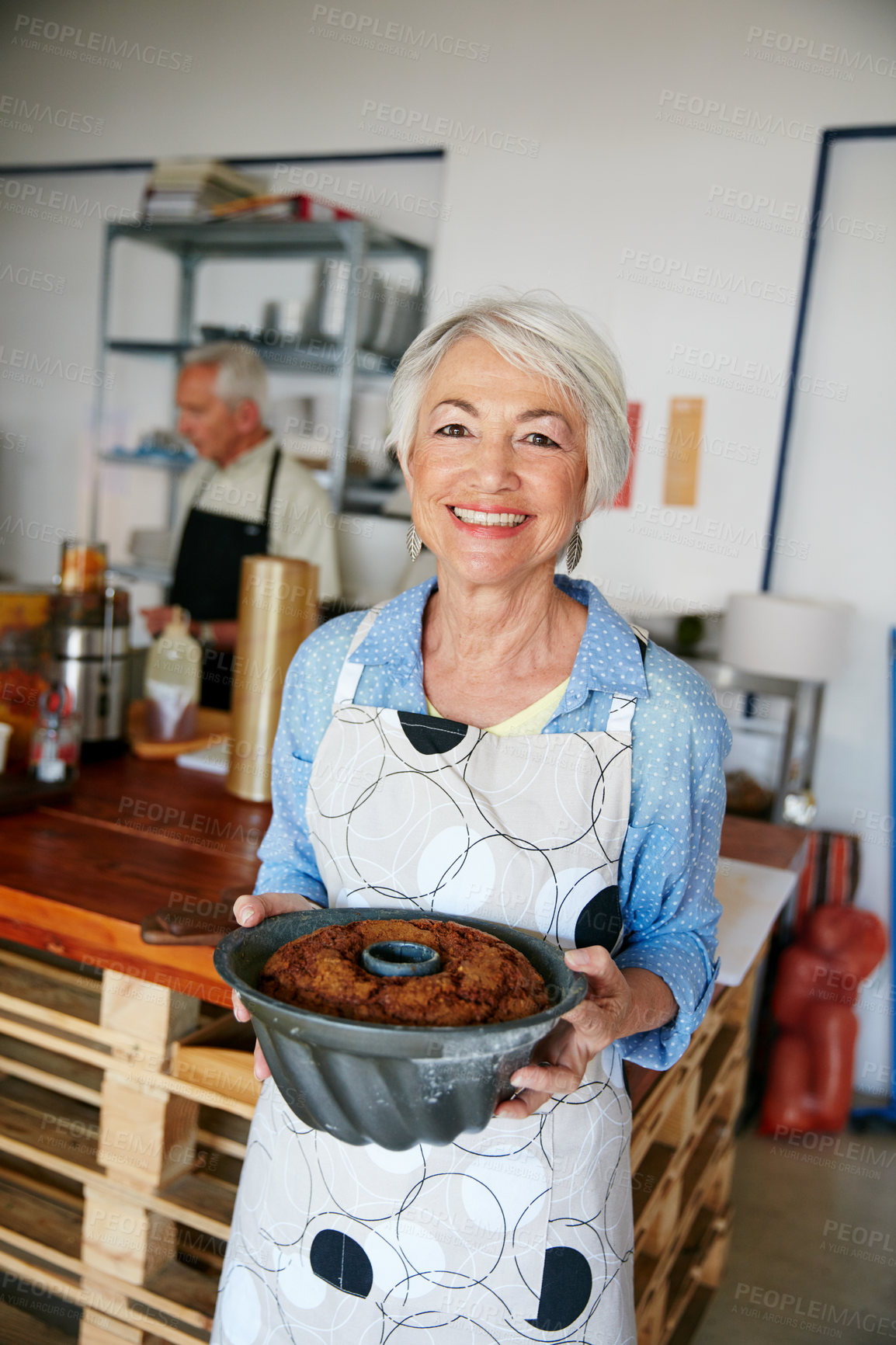 Buy stock photo Shot of a senior woman working in a bakery