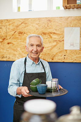 Buy stock photo Shot of a senior man working in a coffee shop