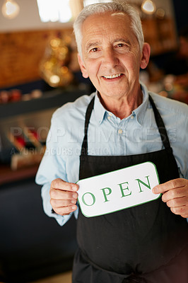 Buy stock photo Portrait of a senior man holding up a sign on opening day of his small business