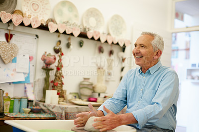 Buy stock photo Shot of a senior man making a ceramic pot in a workshop