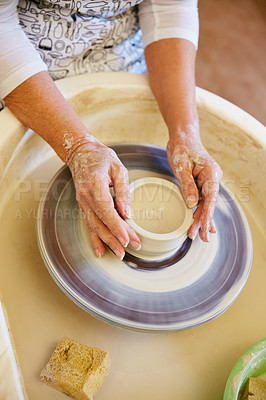 Buy stock photo Cropped shot of a woman making a ceramic pot in a workshop