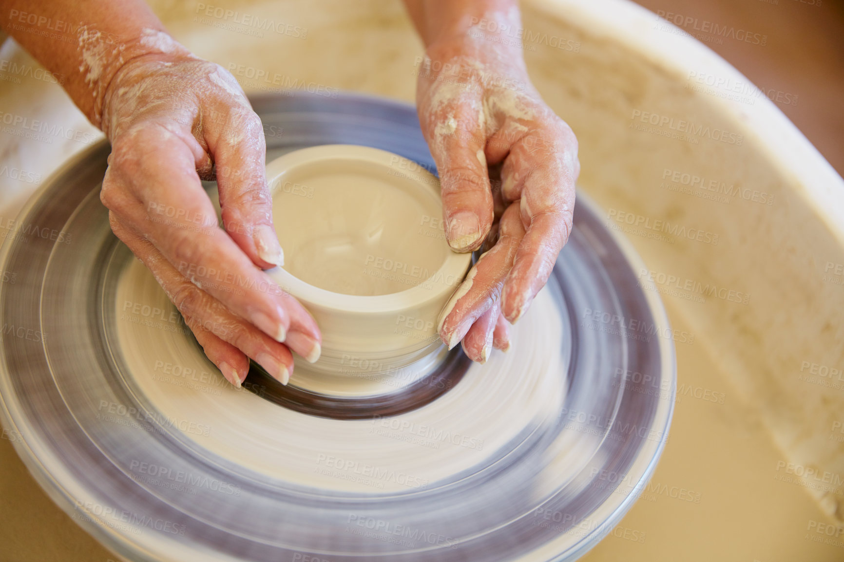 Buy stock photo Cropped shot of a woman making a ceramic pot in a workshop