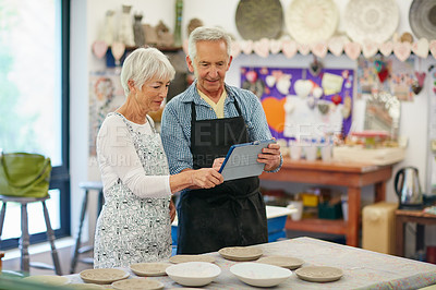 Buy stock photo Shot of a senior couple working with ceramics in a workshop