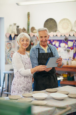 Buy stock photo Shot of a senior couple working with ceramics in a workshop