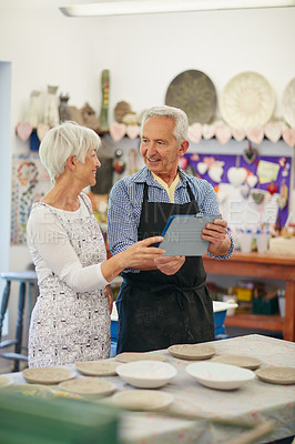 Buy stock photo Shot of a senior couple working with ceramics in a workshop