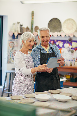 Buy stock photo Shot of a senior couple working with ceramics in a workshop