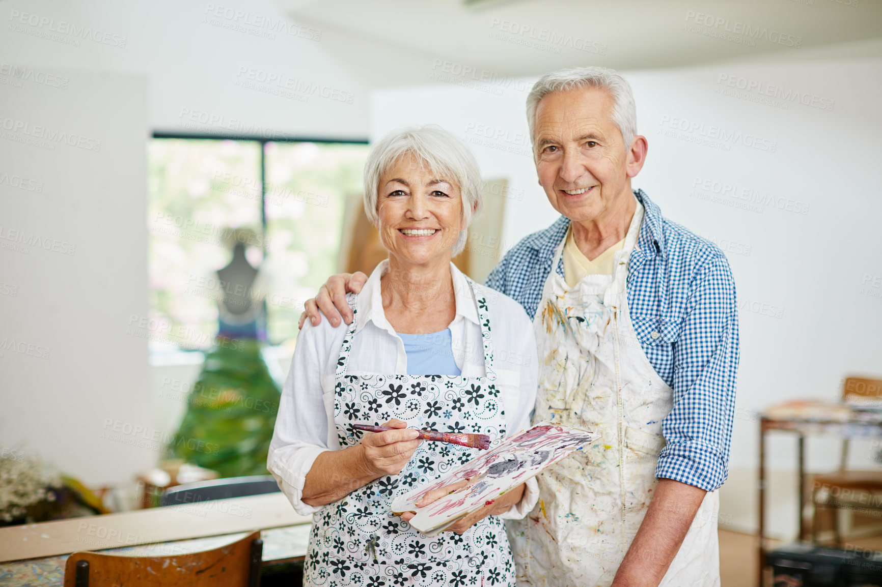 Buy stock photo Shot of a senior couple painting at home
