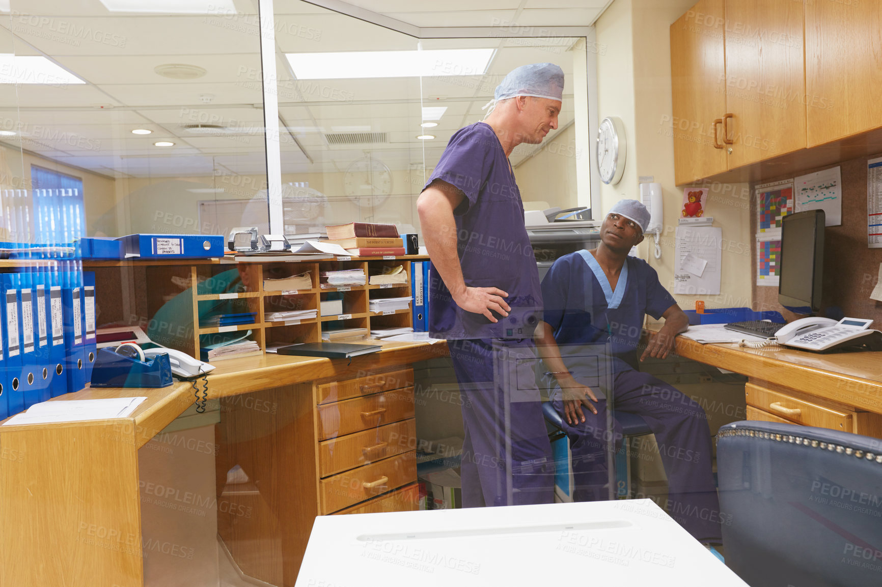 Buy stock photo Shot of two surgeons having a discussion in a hospital
