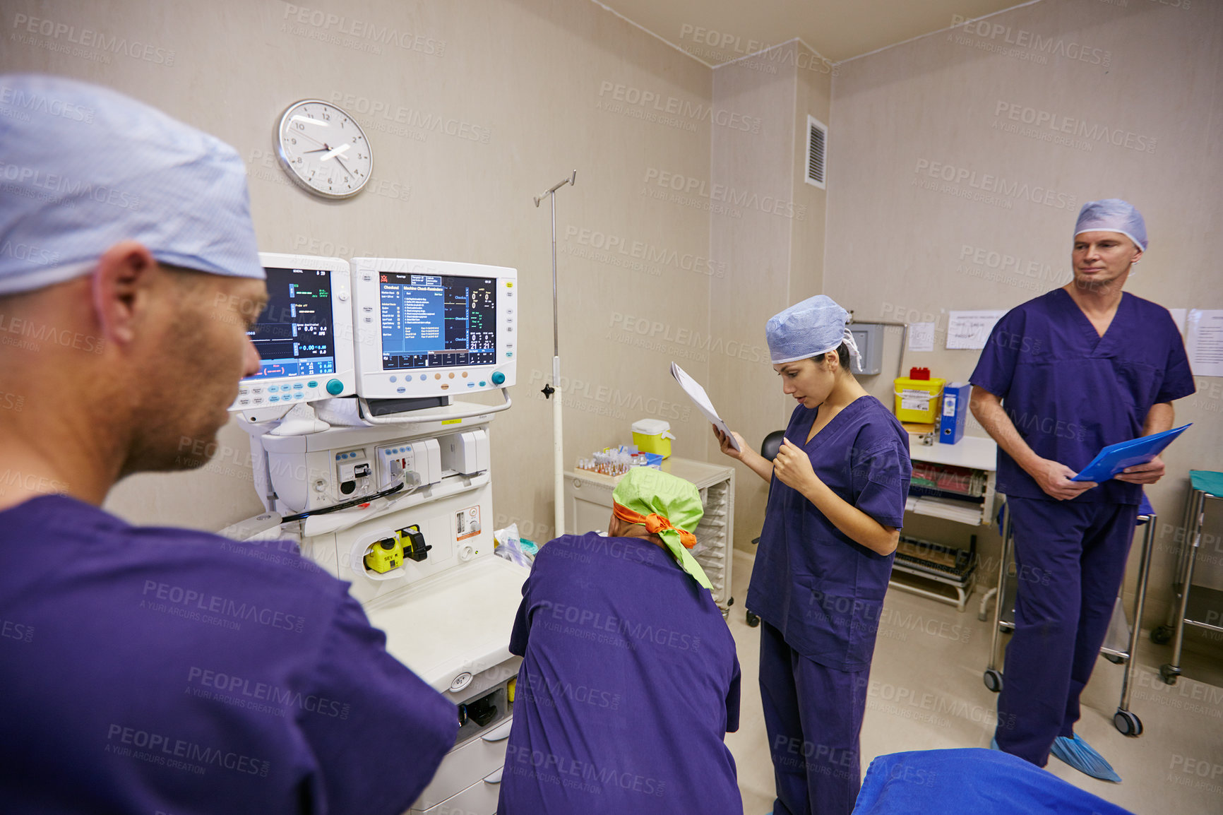Buy stock photo Shot of a team of surgeons preparing for a surgery