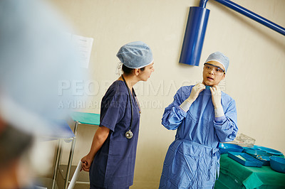 Buy stock photo Shot of surgeons preparing for a surgery