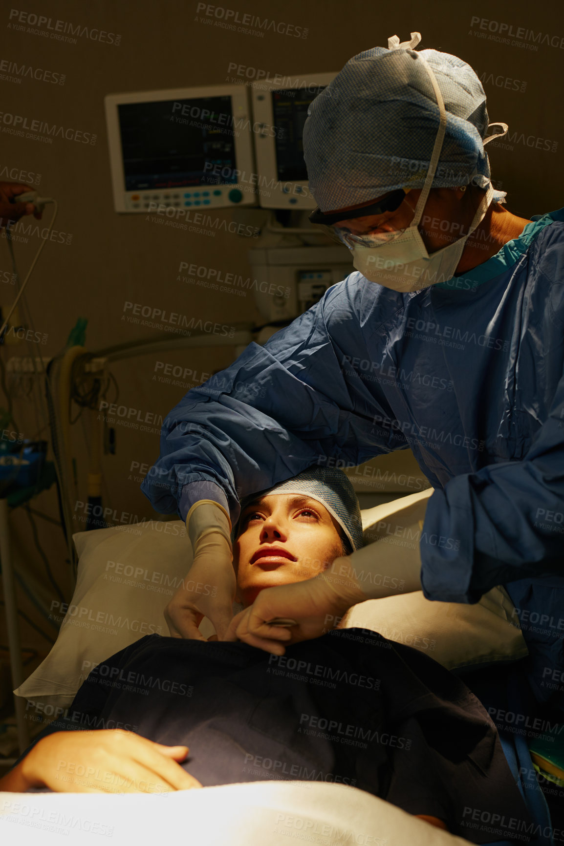 Buy stock photo Shot of a surgeon preparing a patient for her surgery