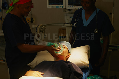 Buy stock photo Shot of a surgeon administering anesthetic to a patient before her surgery
