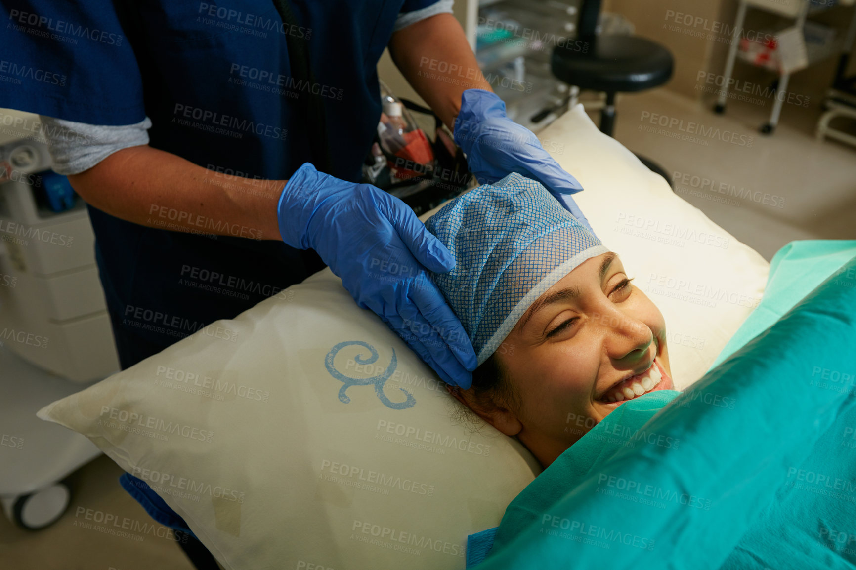 Buy stock photo Shot of a nurse putting a surgical cap on a patient in preparation for her surgery