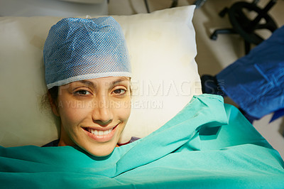 Buy stock photo Portrait of a happy young woman lying in a hospital bed before her surgery
