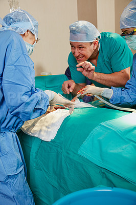 Buy stock photo Shot of a surgeon giving his colleague advice during a surgical procedure
