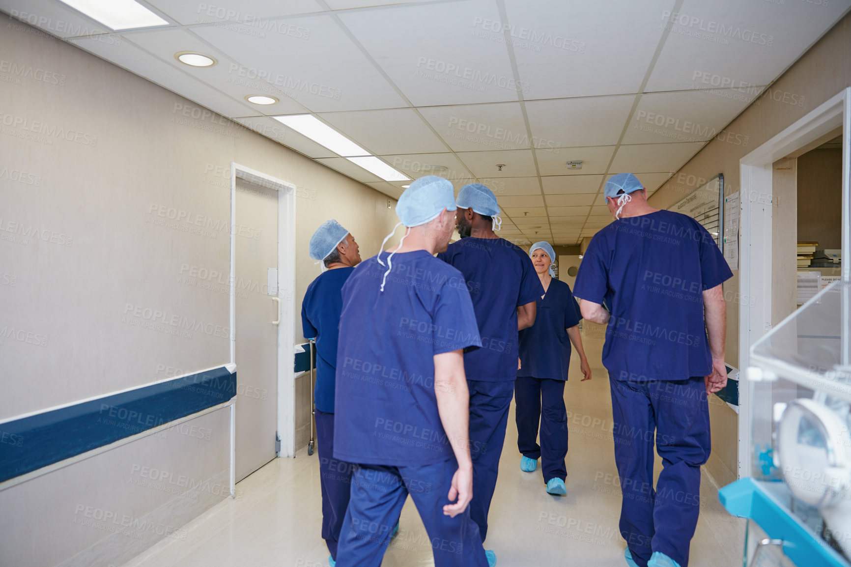 Buy stock photo Rearview shot of a medical team standing in a hospital