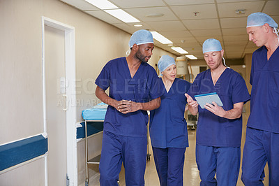Buy stock photo Cropped shot of a medical team standing in a hospital