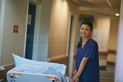 Buy stock photo Cropped portrait of a female nurse standing beside a hospital bed