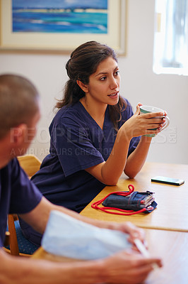 Buy stock photo Shot of medical practitioners having a chat while on their tea break