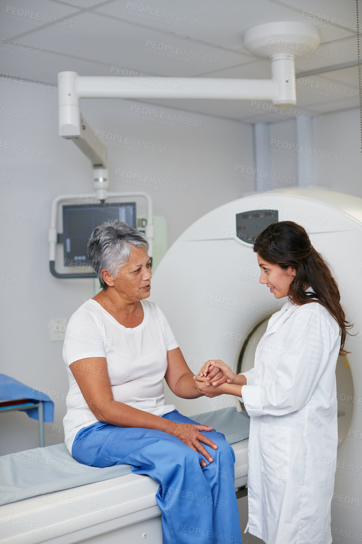 Buy stock photo Doctor, mri and woman holding hands of patient in hospital before scanning in machine. Ct scan, comfort or medical professional with senior female person in radiology test for healthcare consultation