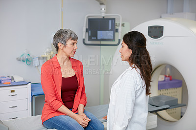 Buy stock photo Shot of a mature woman talking with a doctor before and MRI scan