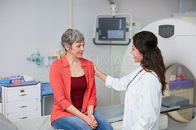 Buy stock photo Shot of a mature woman being comforted by a doctor before and MRI scan